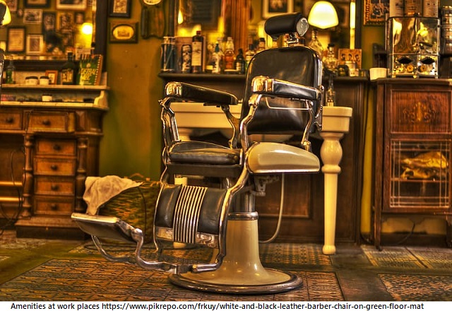 white-and-black-leather-barber-chair-on-green-floor-mat